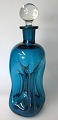 Holmegård glas 
klukflaske, 
1960'erne,søblåt 
glas. Med klar 
glasprop. H.: 
28 cm. 
Kugleslebet i 
...