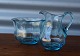 Holmegaard skål 
i lyseblåt 
glas, 
skylleskål
Flødekanden er 
 solgt
mål på Skålen
Højde: 7,5 cm 
...