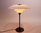 PH 4/3 
bordlampe, 
designet af 
Poul Henningsen 
og fremstillet 
af Louis 
Poulsen i 
1930'erne, er 
en ...