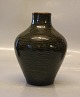 20824 Kgl. Vase 
17 cm 
Stiliserede 
"Levende Sten" 
i riflet stil 
grønlig Olivin? 
glasur Axel 
Salto ...