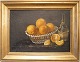 1900-tals 
stilleben 
maleri. 
Stilleben med 
appelsiner i 
kurv samt 
vinflaske på 
bord.  
Olie på ...