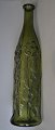 Grøn flaske, 
figur flaske 
20. årh. Sider 
dekoreret med 
blomster og 
bladværk. 
Formstøbt. 
Højde.: ...