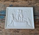 Bing & Grøndahl 
Bisquit "Amor 
og den unge 
Bacchus stamper 
druer" Kopi af 
relief 
modelleret i 
...