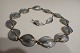 David Andersen 
(1880 - 1980), 
forgyldt, 
sterling sølv 
halskæde og 
øreklips med 
grå emalje på 
...