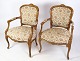 Et par nyrokoko 
armstole med 
dekorativt stof 
i lyst træ fra 
omkring 
1930'erne er en 
smuk ...