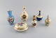 Limoges, 
Frankrig. To 
parfumeflakoner, 
tre vaser og 
lågskrin i 
håndmalet 
porcelæn. 
Blomster og ...