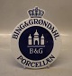 Bing & Grøndahl 
Porcelæn 
forhandlerskilt 
med krone  til 
væggen 19 x 16 
cm I fin og hel 
stand. 
