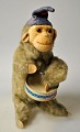 Mekanisk abe 
spillende på 
tromme, 20. 
årh. Tyskland. 
Med hue. H. 17 
cm. 
Made in West 
Germany. 