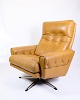 Lænestolen i 
brun læder, et 
eksempel på 
dansk design 
fra 1980'erne, 
udstråler både 
komfort og ...