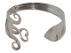 Dansk sølv, 
armbånd lavet 
ud af et stykke 
bestik.
Måler 6,5 x 
5,3 cm.
Fin og 
velholdt stand.