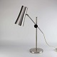 Skrivebordslampe 
med fod i stål 
og skærm i 
aluminium. 
Lampen og 
skærmen kan 
reguleres i 
højde og ...
