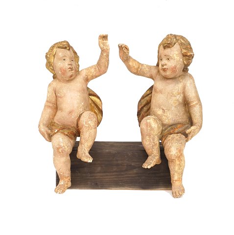 A pair of Baroque putti, wood. Sweden circa 1750. 
H: 55cm. B: 55cm