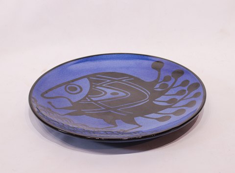 Large round ceramic dish with dark blue glaze and motif of a fish, by 
Pottemagerstuen at Graabrødretorv 1.
5000m2 showroom.