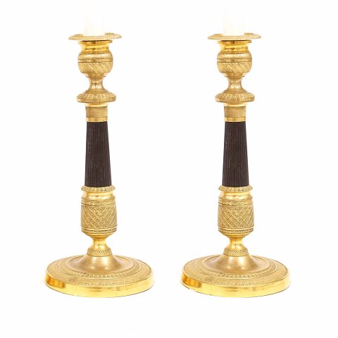 A pair of fire gilt bronze candlestick. France 
circa 1820. H: 27cm