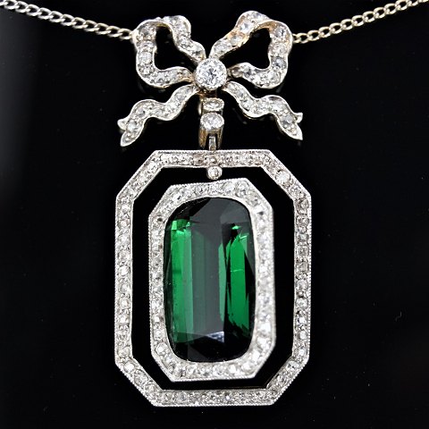 A necklace set with a tourmaline, a brillant and diamonds mounted in gold and 
white gold