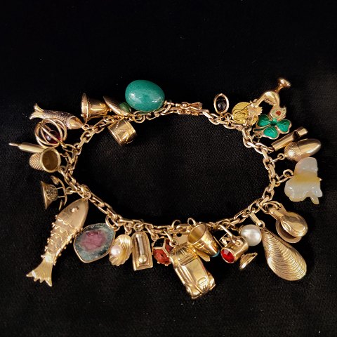 A bracelet of 14k gold set with 28 charms