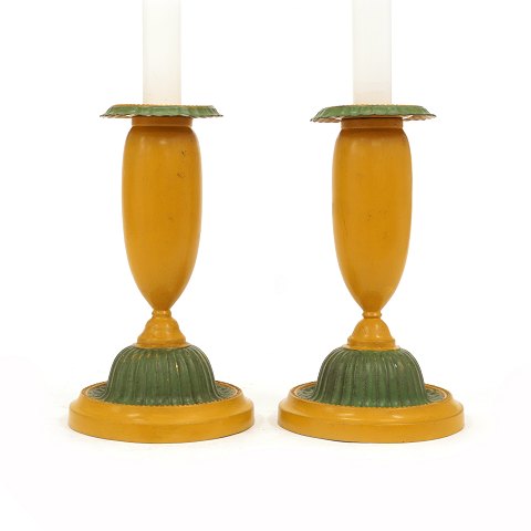 A pair of green and yellow decorated pair of 
candle sticks. Denmark circa 1840-50. H: 19cm