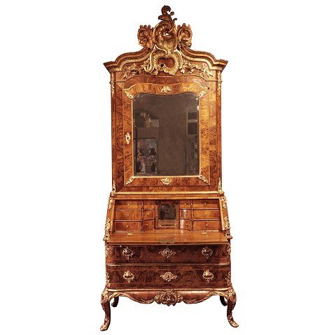 Signed Danish Rococo bureau from the royal castle 
Hirscholm by Mathias Ortmann, Copenhagen circa 
1750. Gilt walnut with the original mirror. 
Ortmann was the leading Rococo cabinetmaker in 
Copenhagen.
H: 258cm. W: 110cm. D: 62c