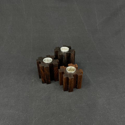 A set of modern candles in rosewood