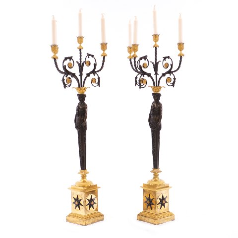 Et par kolosalle lueforgyldte bronzekandelabre med 
sortpatineret stamme. Frankrig ca. år 1810-20. H: 
99cm