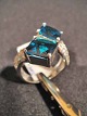 Ring with two 
stair-milled 
blue crystals.
 edge of the 
ring inserted 
numerous 
brilliant-cut 
...
