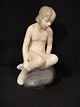 Figure.
 Girl on 
stone.
 Royal 
Copenhagen Rc 
No. 4027
 first sort
 Price D.kr. 
595,-