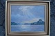 Aage Lundgreen 
(1886-1957):
Solen bryder 
gennem skyerne 
ved sø.
Olie på ...