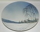 Royal 
Copenhagen 
platte i 
porcelæn med 
motiv af 
vinterlandskab. 
Fremstillet 
mellem 
1900-1923. I 
...