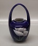 Kgl. 559-29 
Kgl. Vase med 
hank Blomst på 
mørkeblå 
baggrund 20 cm 
Malernr 55 før 
1923 2. sort 
pga ...