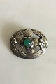 Georg Jensen 
Sterling Sølv 
Broche med grøn 
sten No 138. 
Måler 4 cm. 
Vejer 19,1 
gram. Med gamle 
...