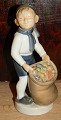 Figur af Hans 
Henrik Hansen 
for Royal 
Copenhagen 
forestillende 
nissedreng med 
gavesæk. Udført 
af ...