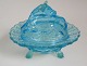 Butter Jar in 
the form of a 
cow in sea blue 
glass. o. 1900