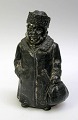 Money Box of 
man in metal, 
19th century. 
The man in the 
big coat, hat 
and carrying a 
bag. H .: ...
