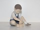 Bing & Grondahl 
figurine, boy 
playing with 
blocks.
The factory 
mark tells, 
that this was 
...