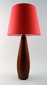 Danish design 
table lamp in 
teak.
Shade in red 
fabric. Denmark 
1950s.
Height: 30 cm. 
Total ...