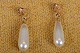 Ørestikker i 
guld med 
dråbeformet 
perler. 
Stemplet 18 K 
3-kroner 
(Serige). Str.: 
L 2,5 cm Art. 
...