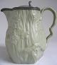 English jug, 
19th century. 
In biscuit with 
lid of tin. 
Decoration in 
shape of 
trees and oak 
...