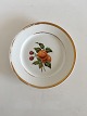 Royal 
Copenhagen 
Plate with 
Handpainted 
Fruit Motif and 
Gold. 22 cm (8 
21/32"). In 
whole ...