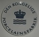 Kgl. 
Reklameskilt 
Kgl.  Den 
Kongelige 
Porcelainsfabrik 
Handlerplatte 
ca 26 cm fra  
Royal ...
