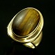 Georg Jensen. 
Ring i 18k Guld 
med Tigerøje 
#1046A.
Tegnet af 
Harald Nielsen 
1892 - ...