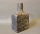 Grå kantet 
keramik 
flaske/vase i 
flot brugt 
stand.
H - 23 cm, B - 
13 cm og D - 9 
cm.