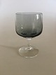 Holmegaard 
"Atlantic" 
Hvidvinsglas. 
11.5 cm H. 
Røgfarvet glas 
med klar stilk. 
Designet af Per 
...