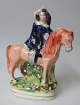 Staffordshire 
fajance figur 
af kvinde til 
hest. ca. 1840. 
England. 
Polykrom 
dekoreret. 
Højde.: ...