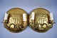 A pair of brass 
wall shields, 
19/20 years. 
With 
candlesticks. 
Decorated with 
lions and 
Amsterdam ...
