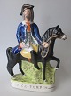 Staffordshire 
figur, røveren 
"Dick Turpin", 
bemalet 
fajance, ca. 
1840, England. 
29 x 21 ...