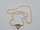 Pearl necklace with 14 carat gold pendant with 8 
diamonds