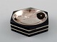 GAB (Guldsmedsaktiebolaget) art deco hexagonal salt cellar in silver and ebony 
with matching salt spoon.