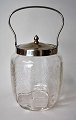 Bisquit bucket 
of glass with 
grindings, 
1900. Handle 
and lid in 
nickel. 
Grindings in 
the form of ...