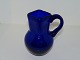 Large dark blue 
glass creamer 
with square 
top.
It is mouth 
blown and from 
around 
1890-1910. ...