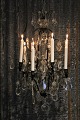 Very beautiful antique crystal chandelier in black iron frame with space for 
eight candles.